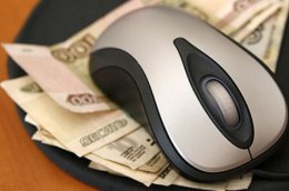 Изображение мышки для компьютера, которая лежит на деньгах